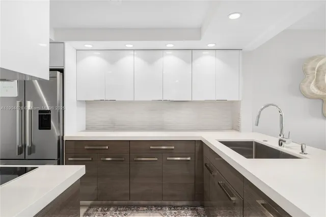 a kitchen with a sink and stainless steel appliances