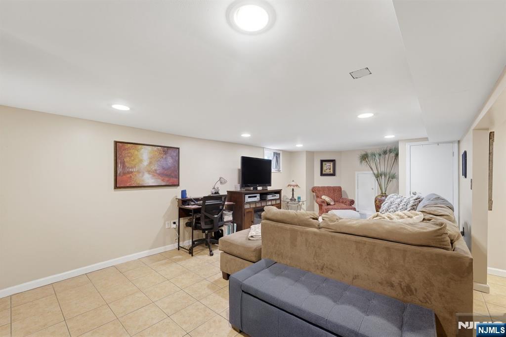 385 Berkeley Avenue Bloomfield, NJ 07003 - Photo 26 of 39 a living room with furniture and a flat screen tv