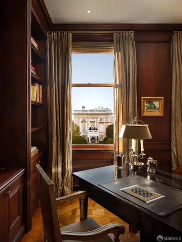 a living room with furniture and a bookshelf