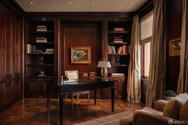 a living room with furniture and a bookshelf