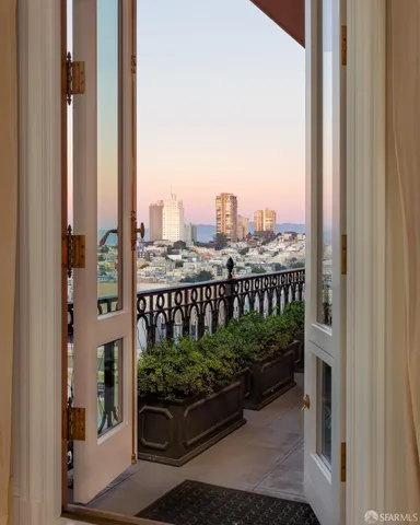 a view of a tall building with a yard and plants