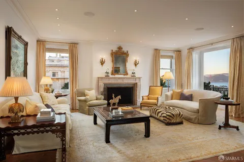 a living room with fireplace furniture and a wooden floor