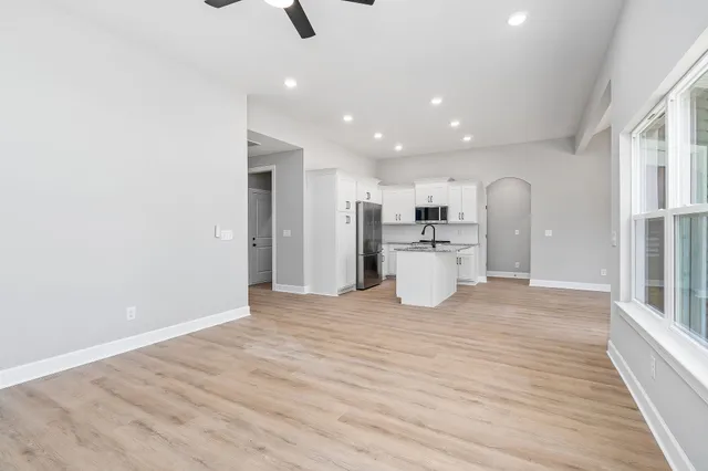 a view of kitchen with refrigerator and window