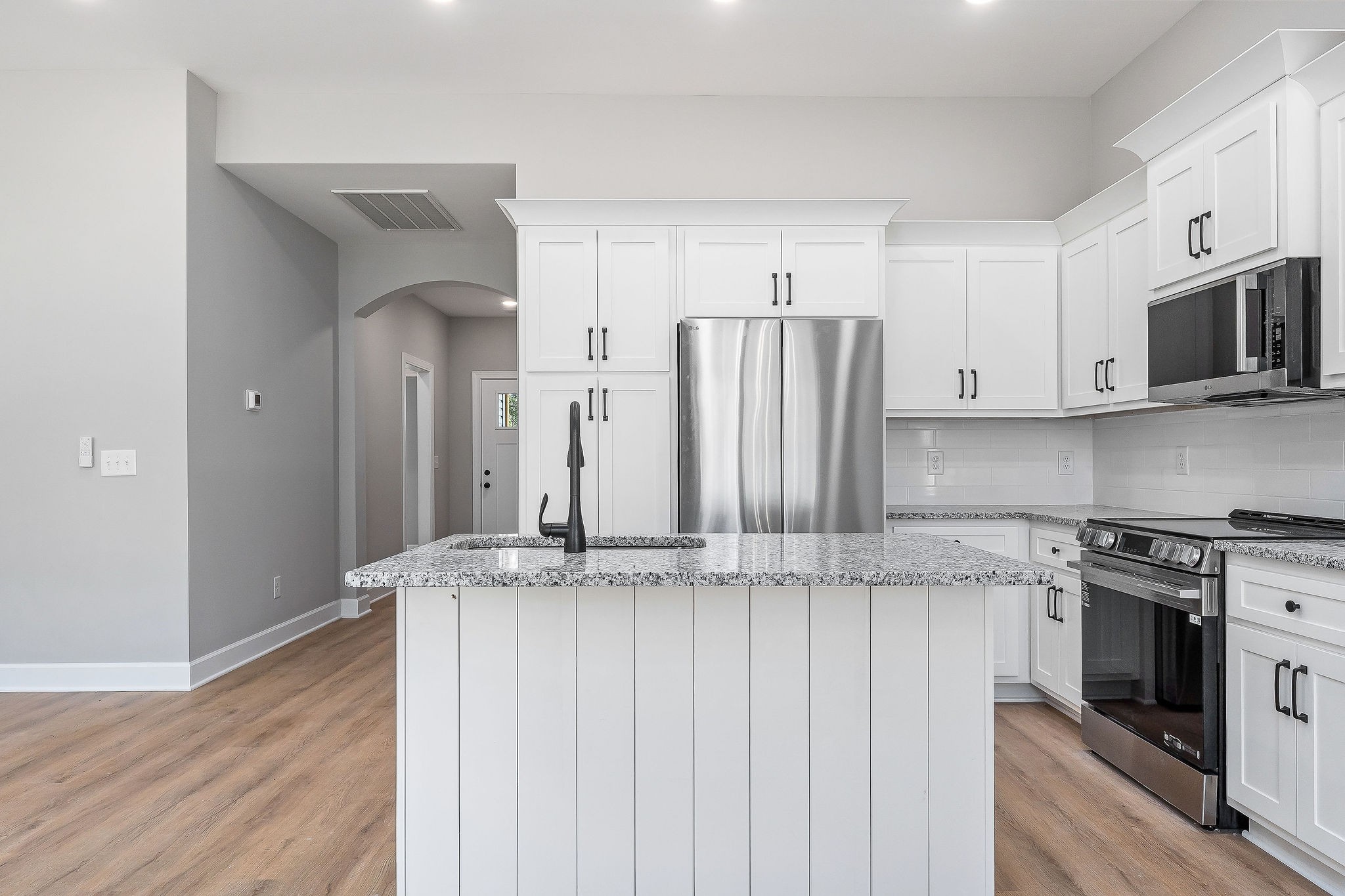 105 Reece Road Baxter, TN 38544 - Photo 15 of 33 a kitchen with stainless steel appliances granite countertop a stove a sink and a refrigerator