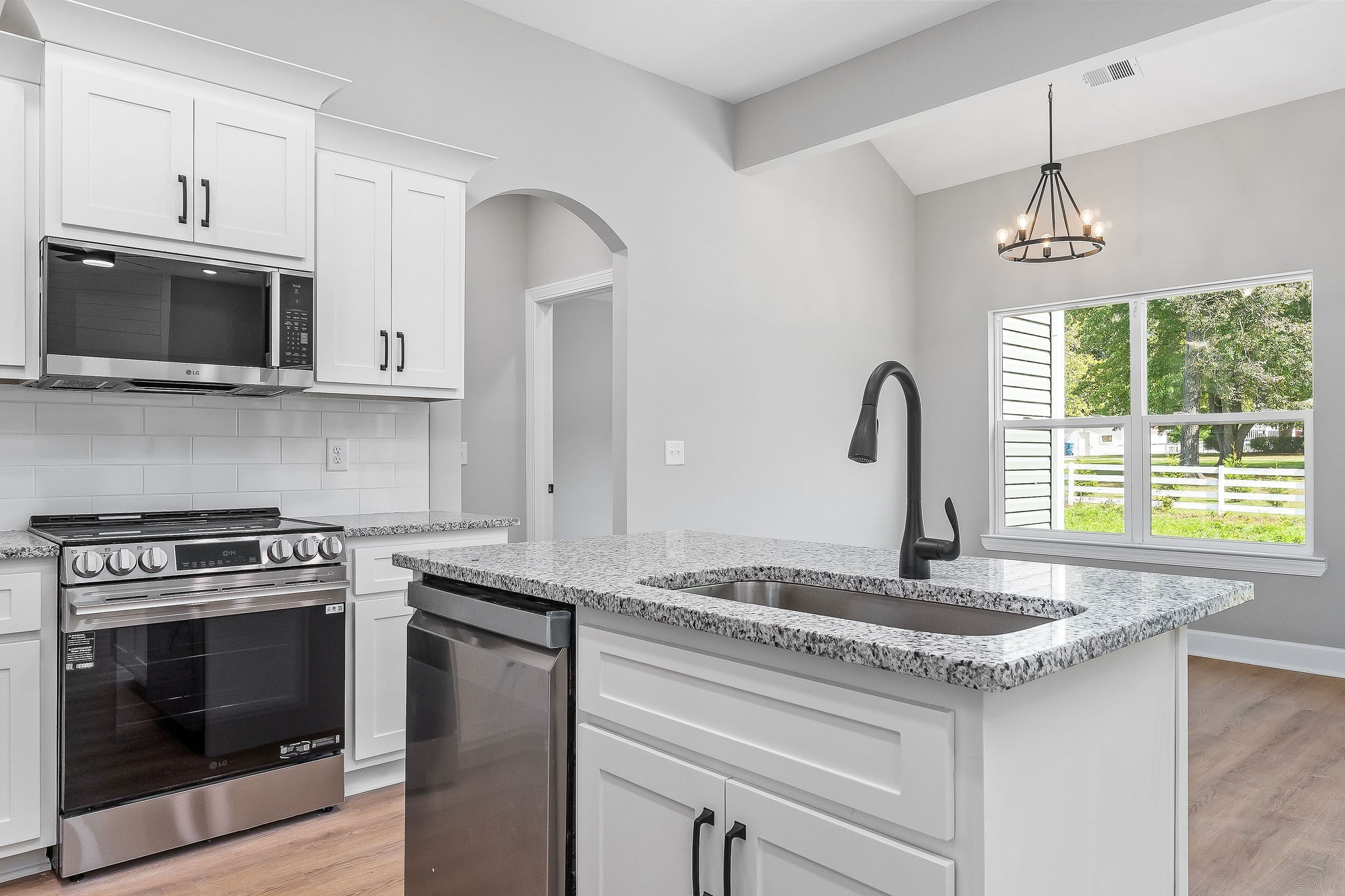 105 Reece Road Baxter, TN 38544 - Photo 16 of 33 a kitchen with granite countertop a sink stainless steel appliances and cabinets