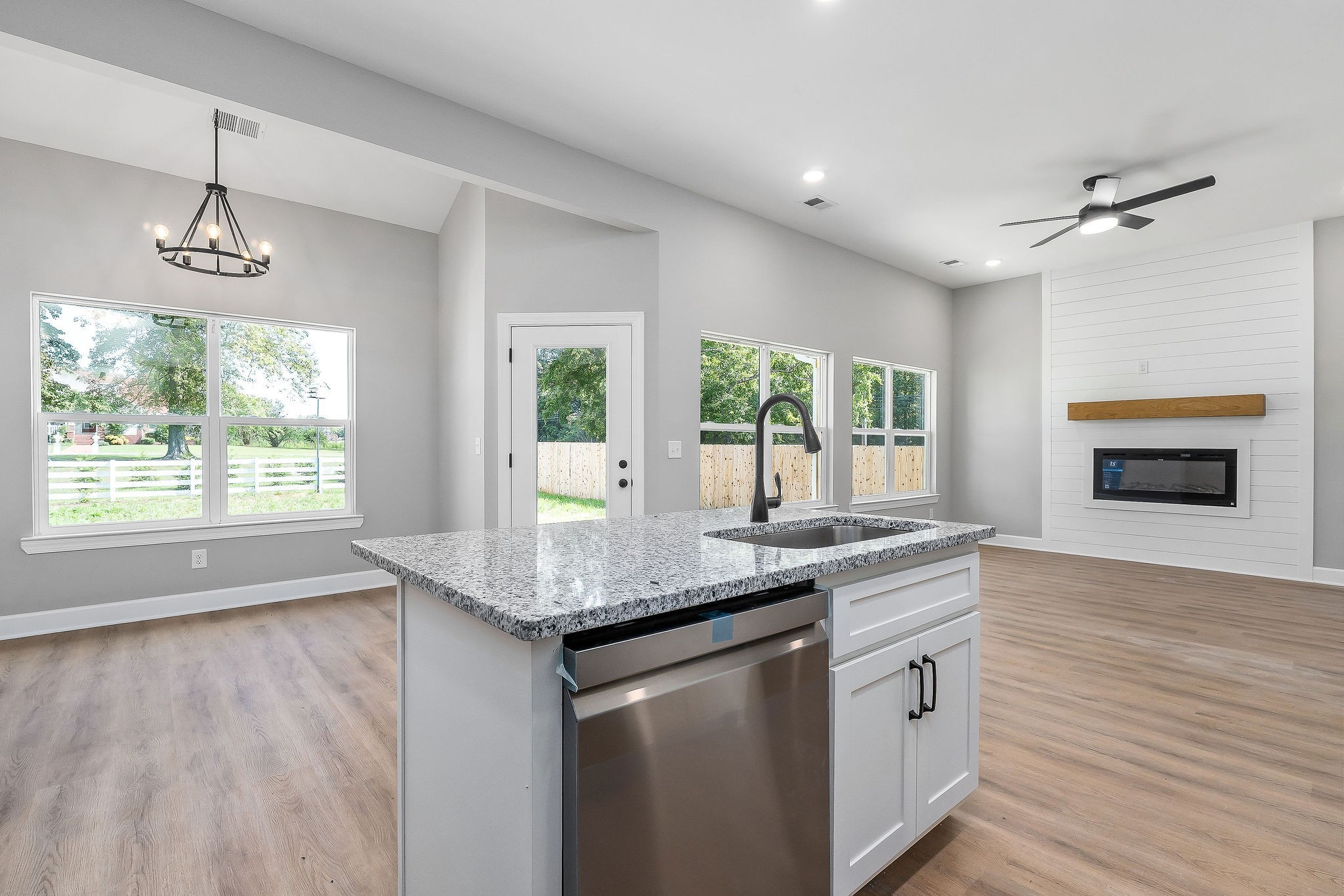105 Reece Road Baxter, TN 38544 - Photo 17 of 33 a kitchen with stainless steel appliances granite countertop a stove a sink and a refrigerator with wooden floors