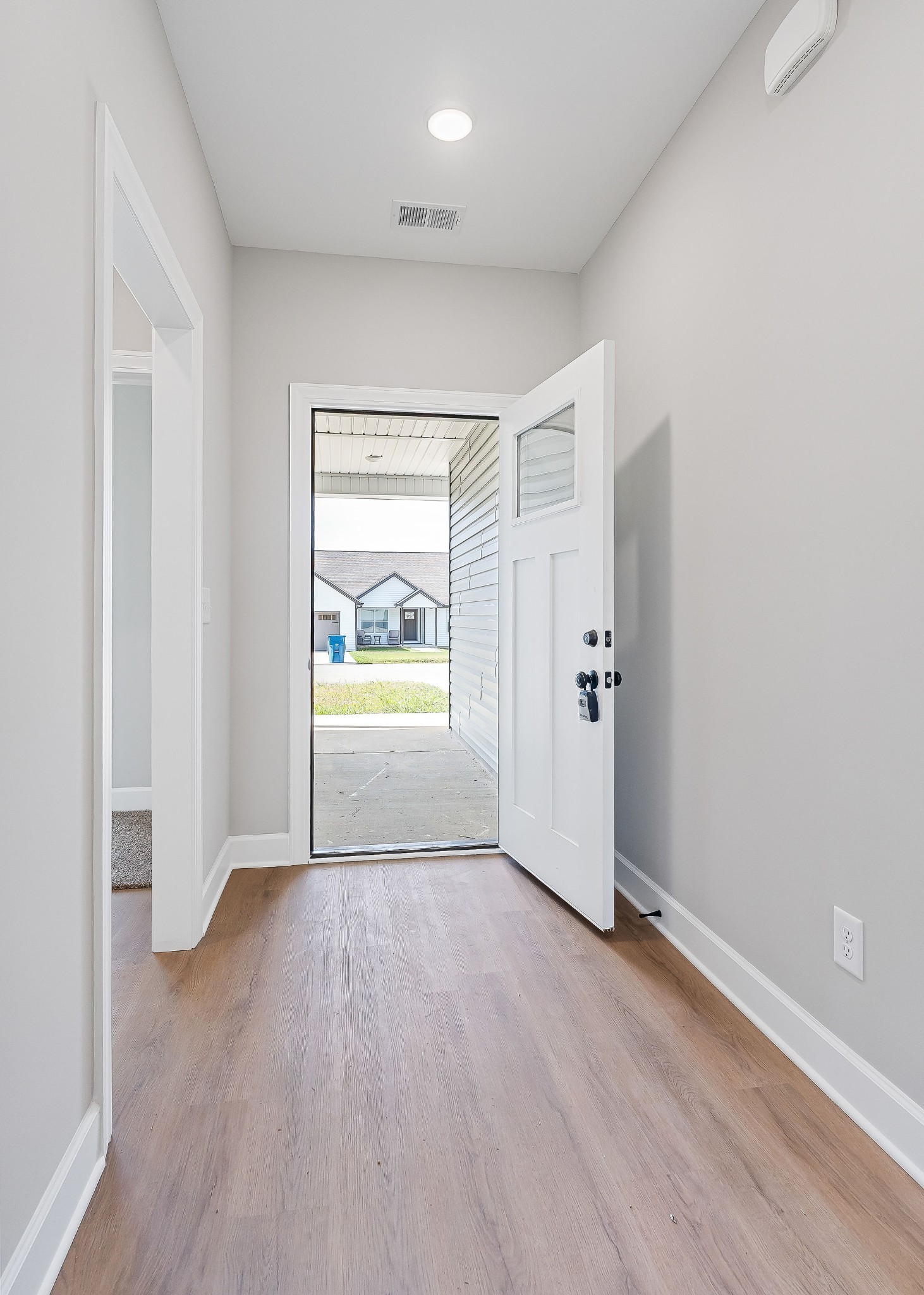 105 Reece Road Baxter, TN 38544 - Photo 2 of 33 an empty room with wooden floor and door