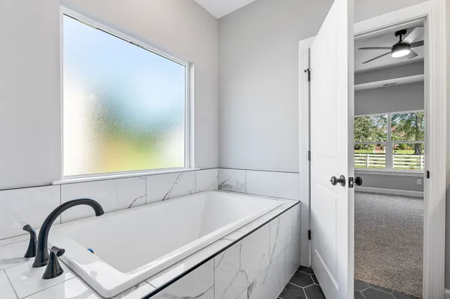 a bathroom with a bathtub and shower