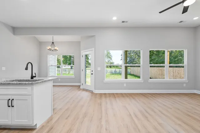 a view of a kitchen with a sink and a large window