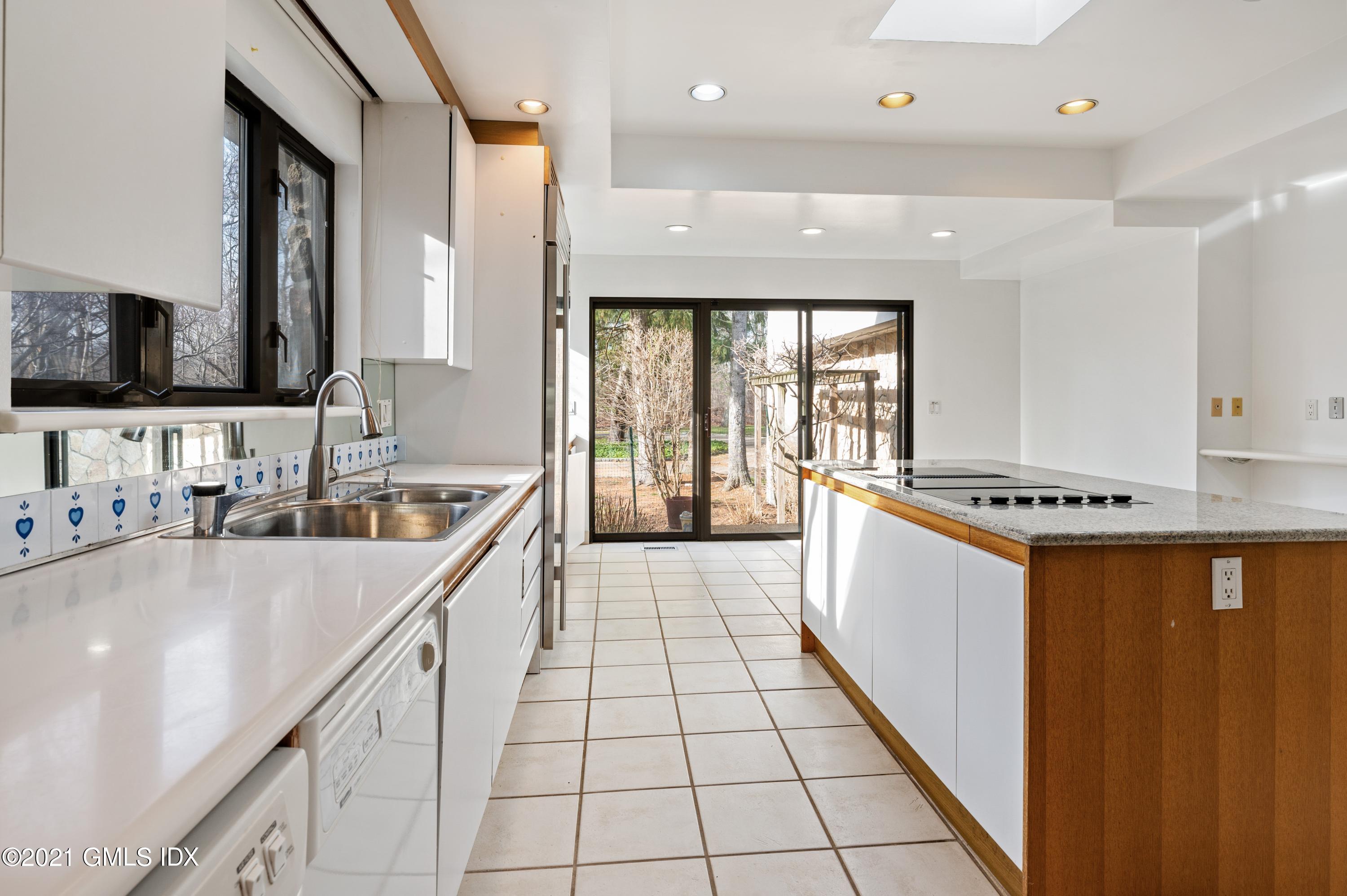 39 Cliffdale Road Greenwich, CT 06831 - Photo 11 of 25 a large white kitchen with a large window