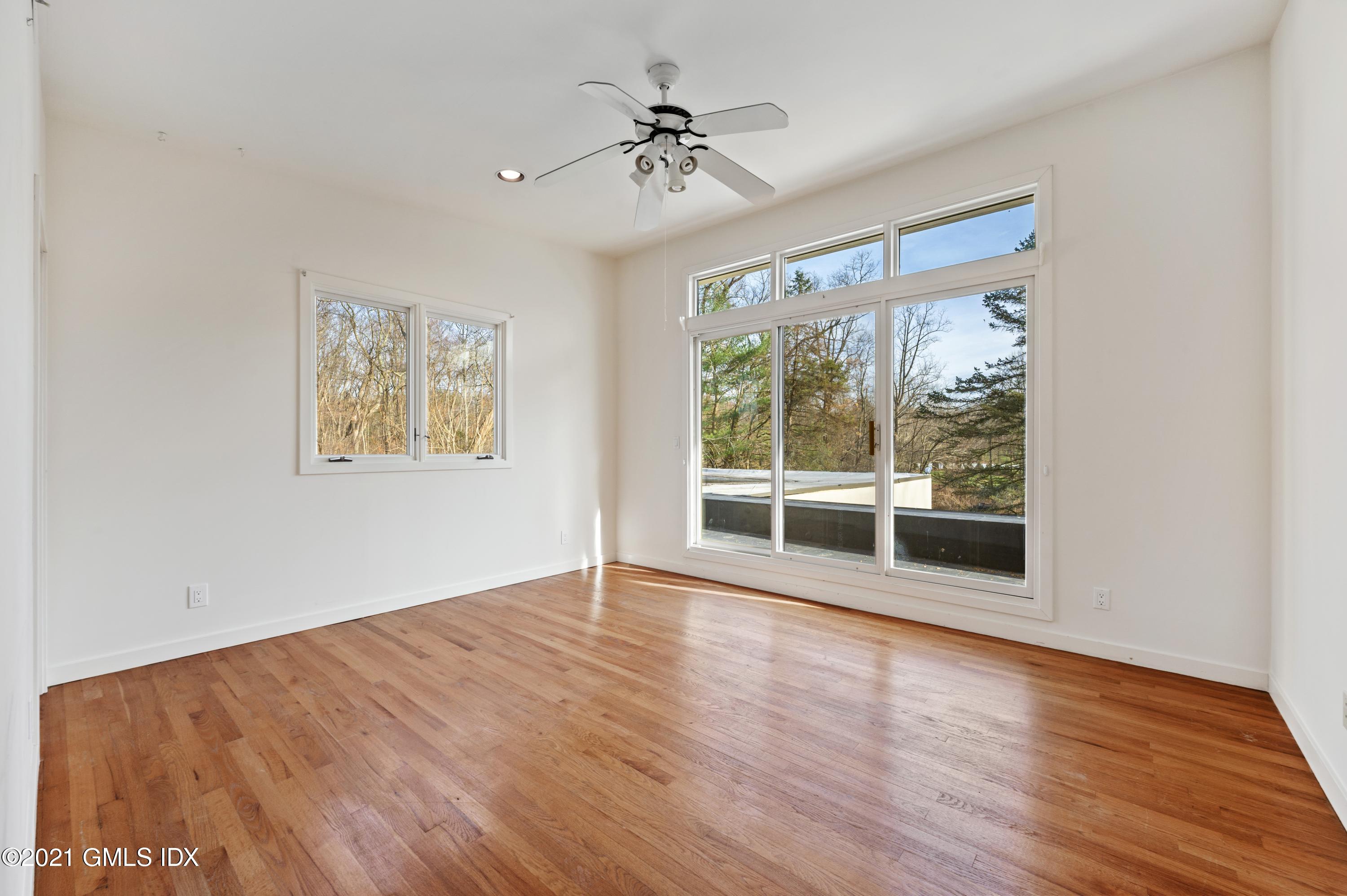 39 Cliffdale Road Greenwich, CT 06831 - Photo 15 of 25 a view of an empty room with wooden floor and a window