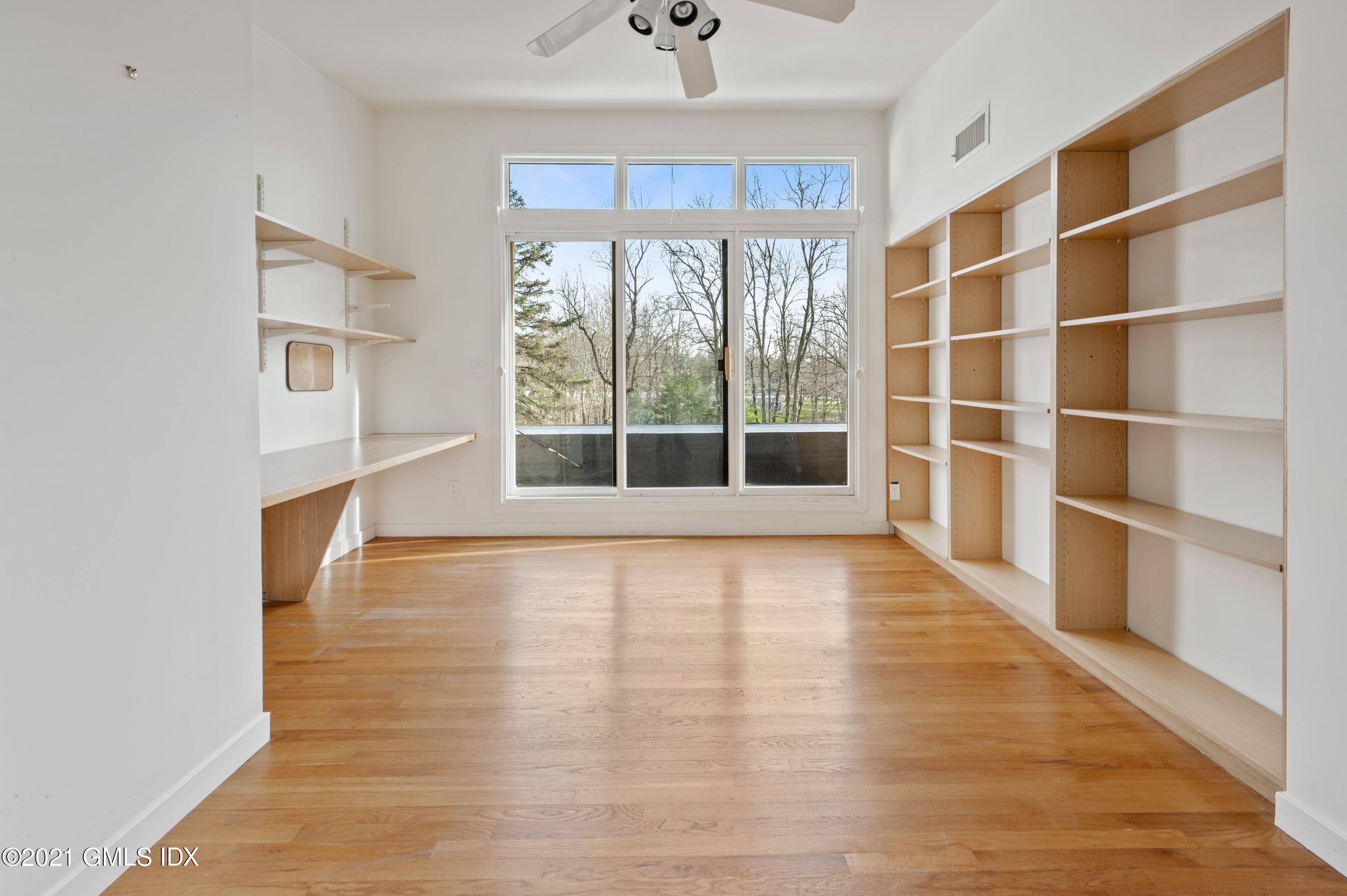 39 Cliffdale Road Greenwich, CT 06831 - Photo 17 of 25 a view of an empty room with a window and wooden floor