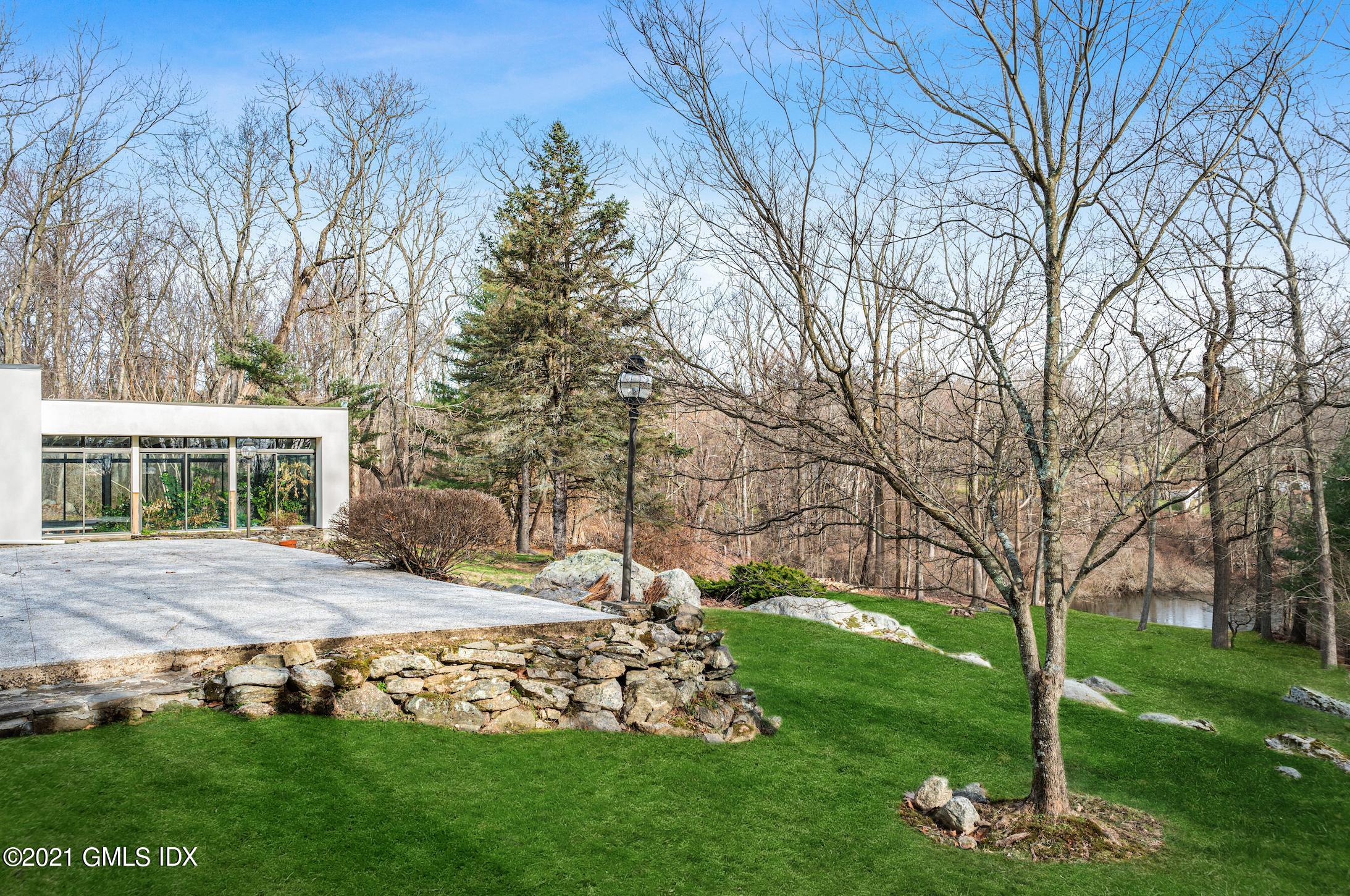 39 Cliffdale Road Greenwich, CT 06831 - Photo 20 of 25 a view of a house with a yard