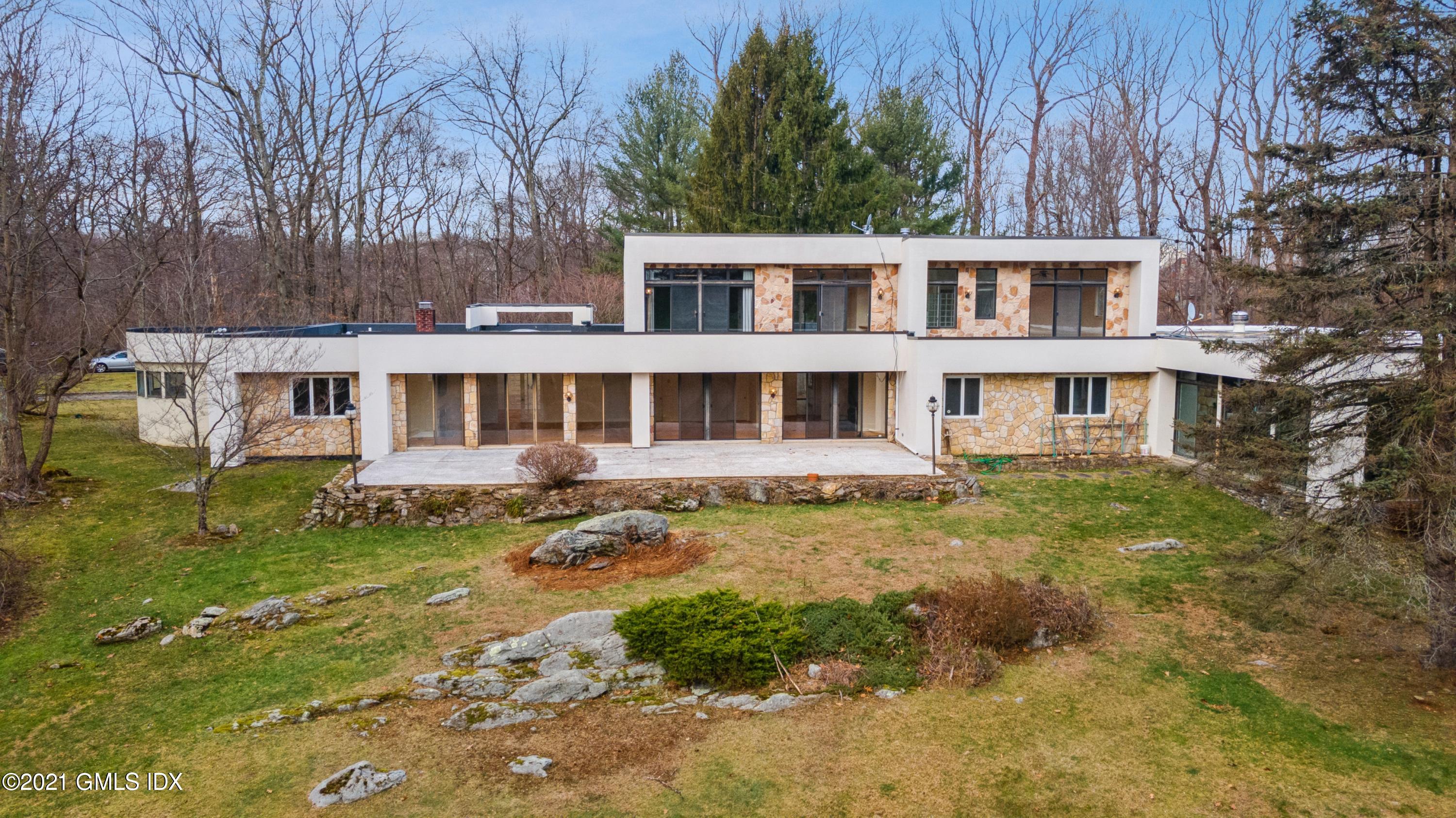 39 Cliffdale Road Greenwich, CT 06831 - Photo 21 of 25 a front view of a house with a yard
