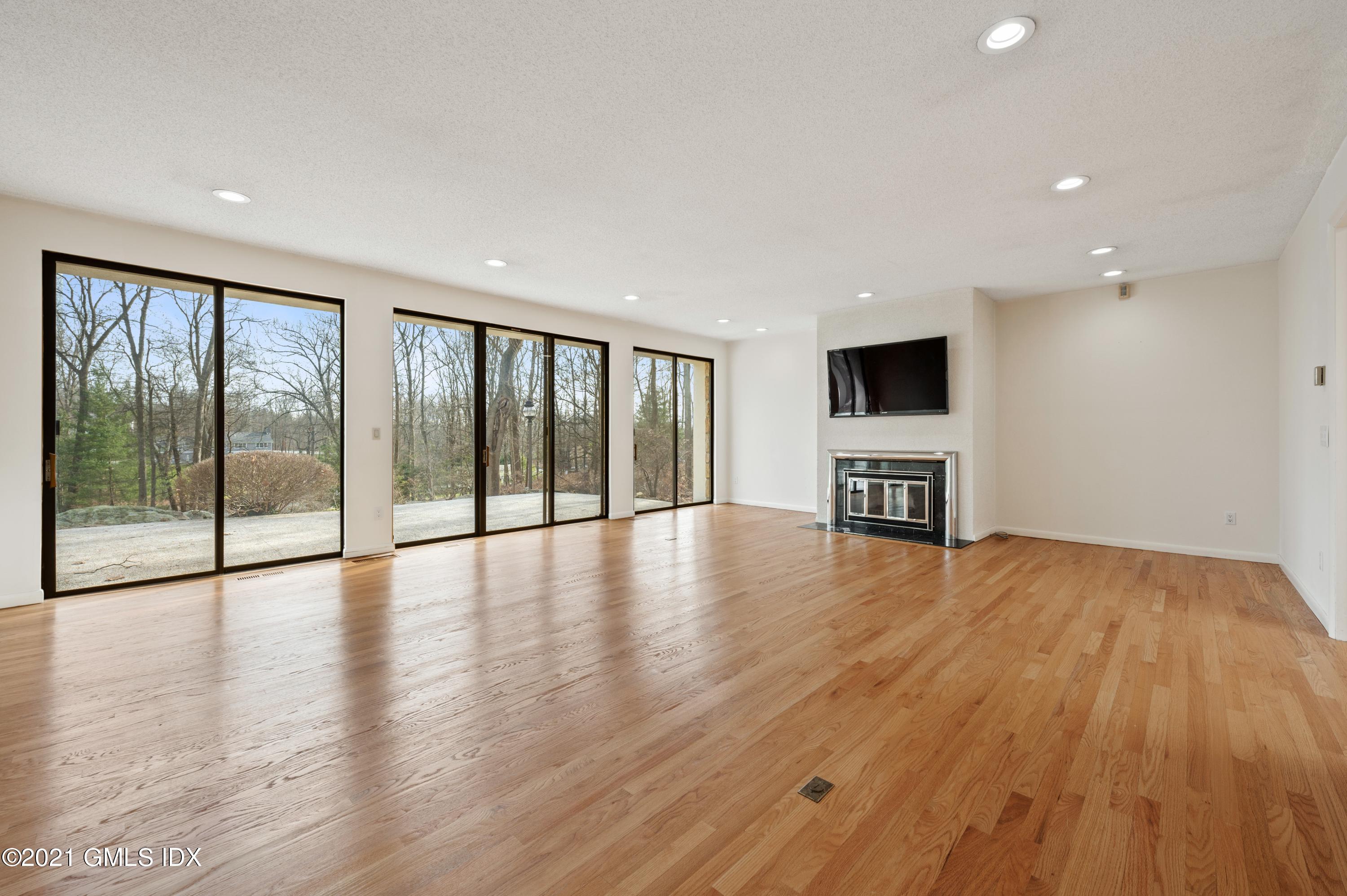 39 Cliffdale Road Greenwich, CT 06831 - Photo 6 of 25 a view of empty room with wooden floor and fireplace