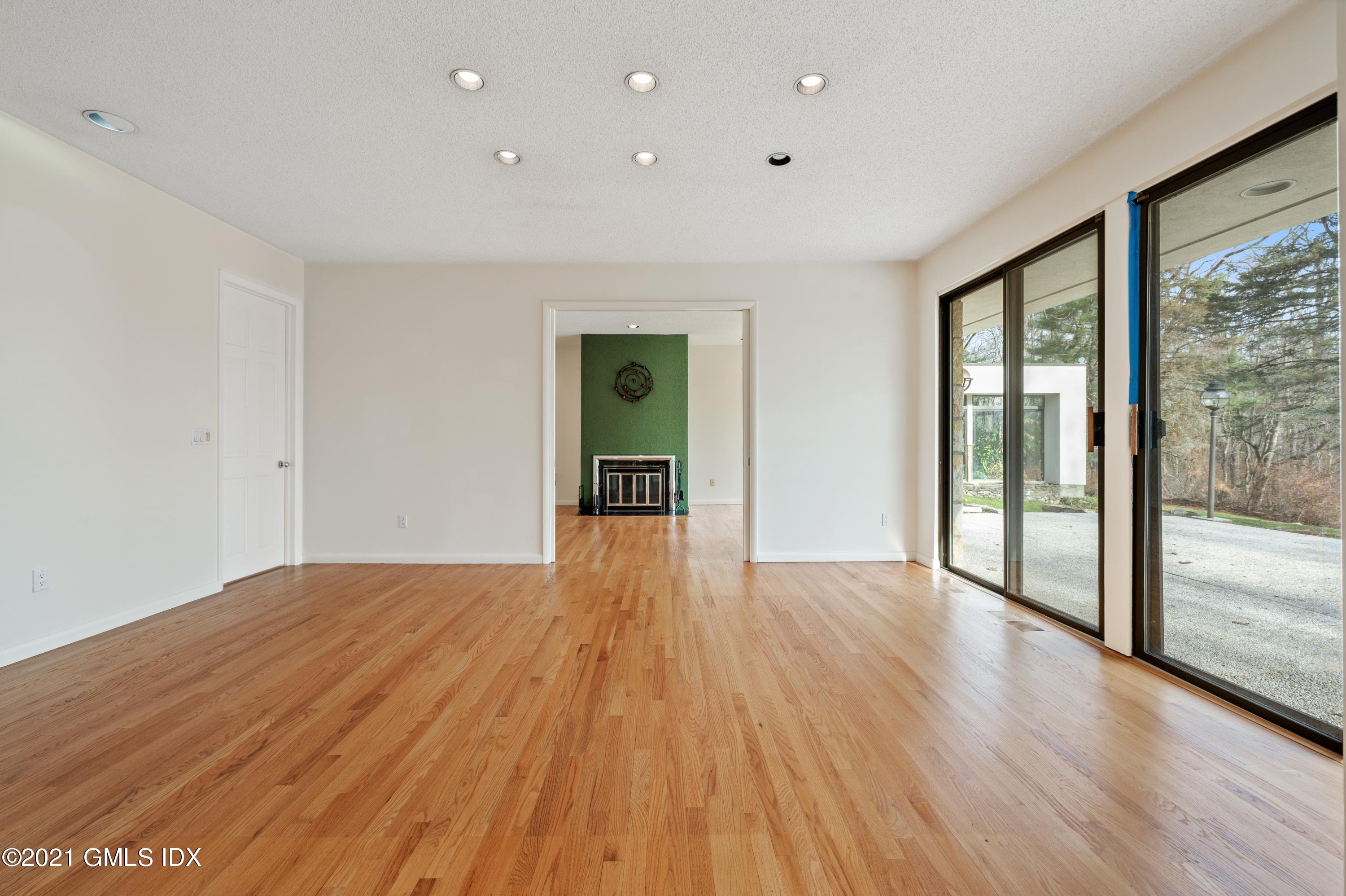 39 Cliffdale Road Greenwich, CT 06831 - Photo 8 of 25 a view of an empty room with wooden floor and a window