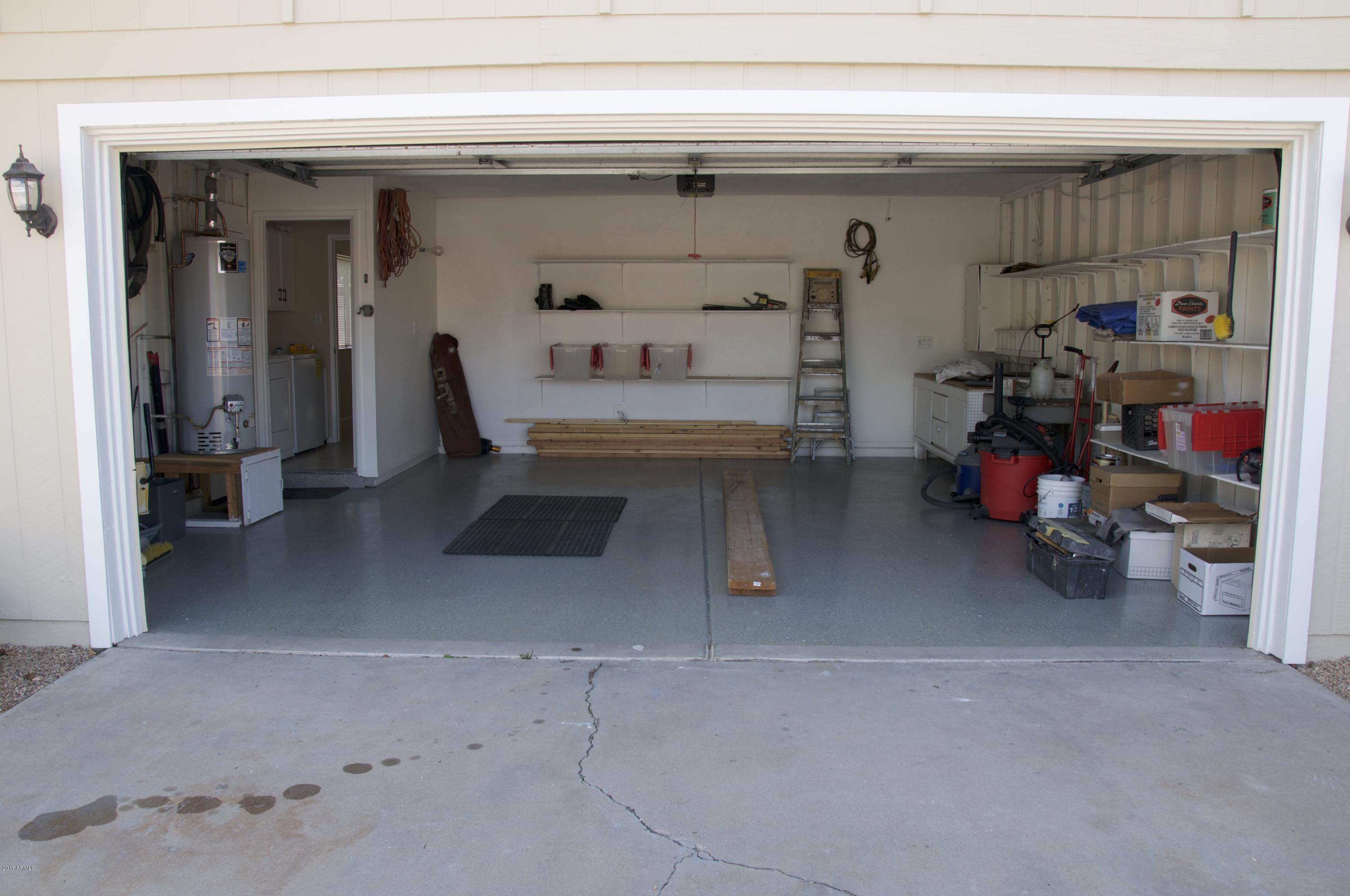 4141 West Hearn Road Phoenix, AZ 85053 - Photo 40 of 42 Shelves, workbench & epoxy floor