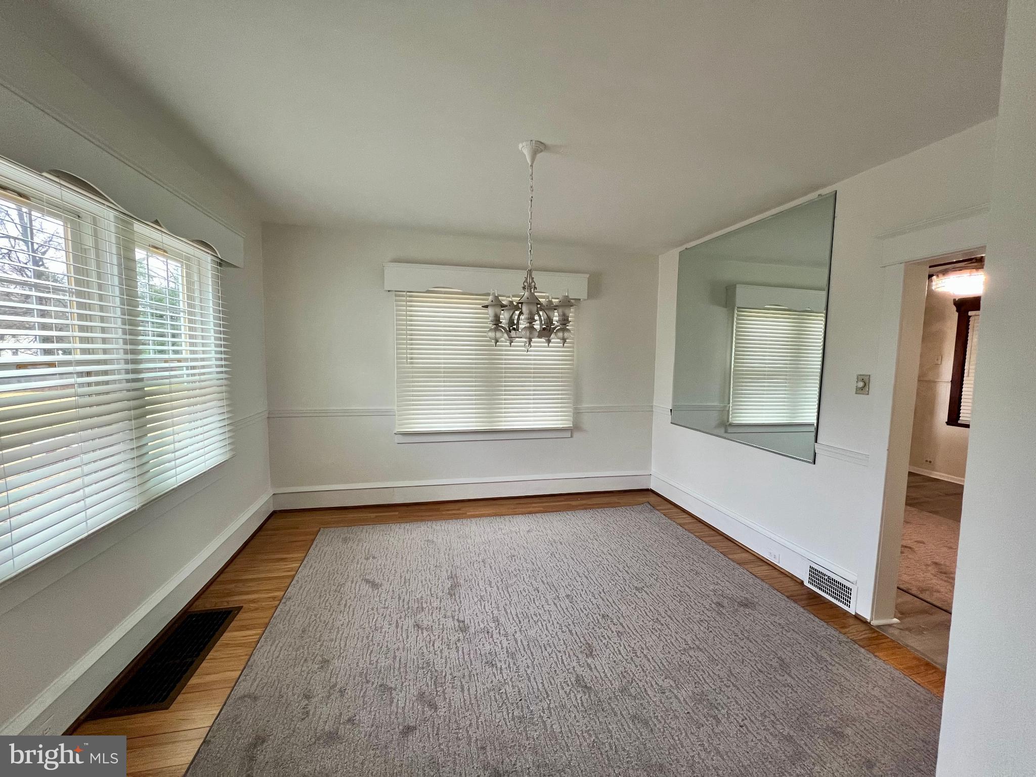 222 Berlin Road North Lindenwold, NJ 08021 - Photo 12 of 26 wooden floor in an empty room with a window