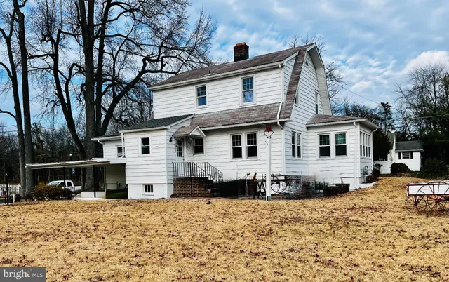 a front view of a house with a yard covered in snow
