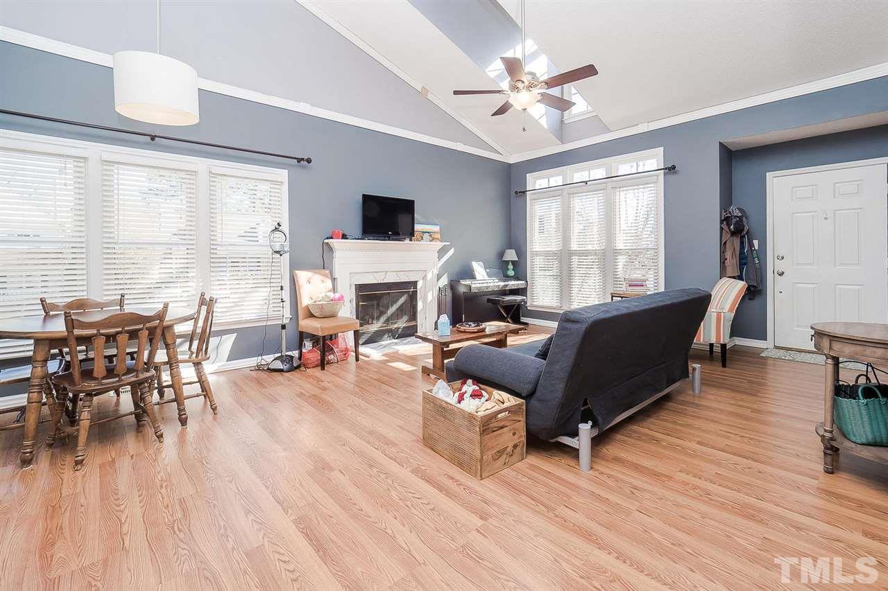 4125 Cobble Court Raleigh, NC 27616 - Photo 2 of 13 a living room with furniture a fireplace and a large window