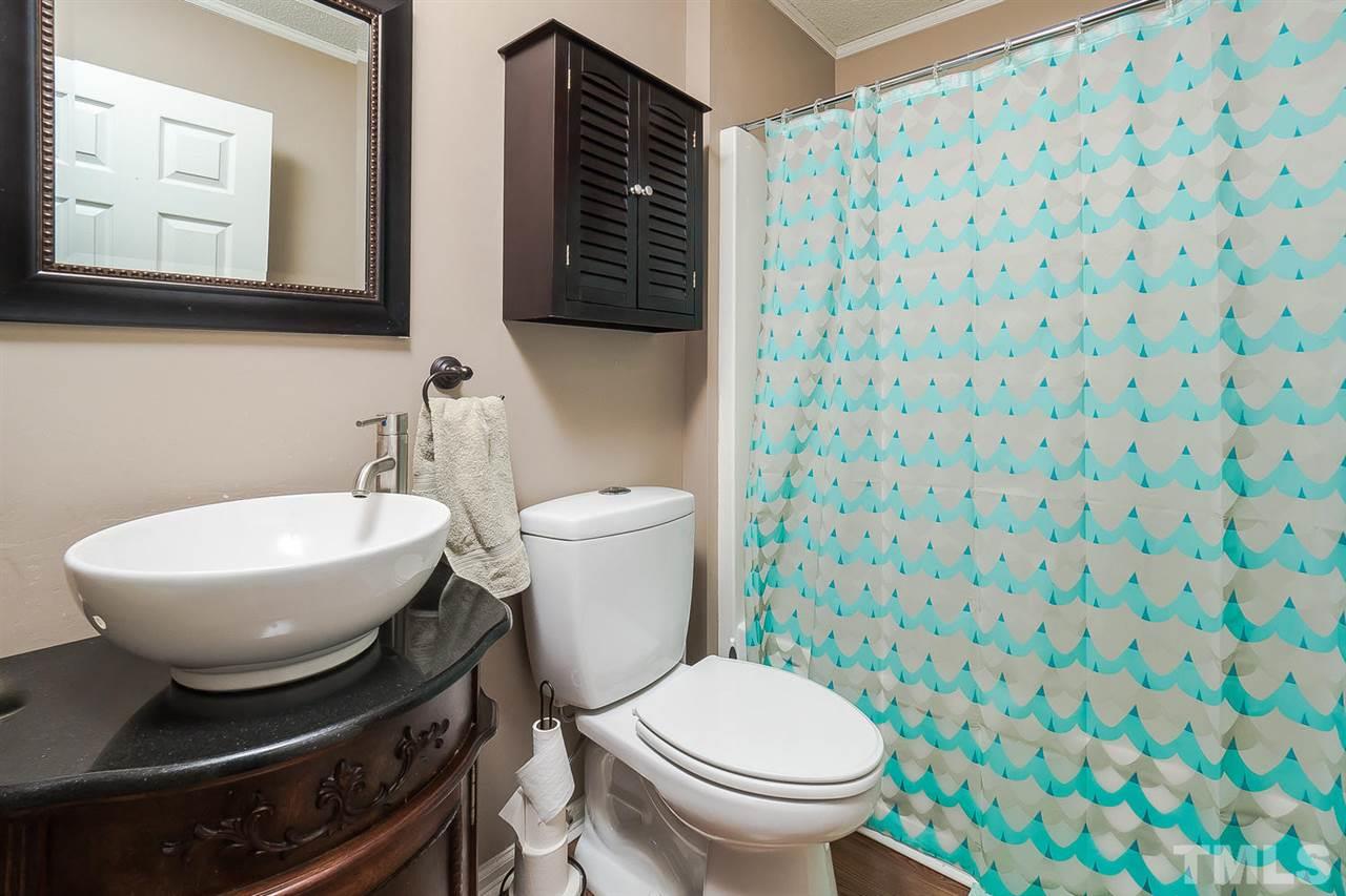 4125 Cobble Court Raleigh, NC 27616 - Photo 11 of 13 a bathroom with a toilet and a sink