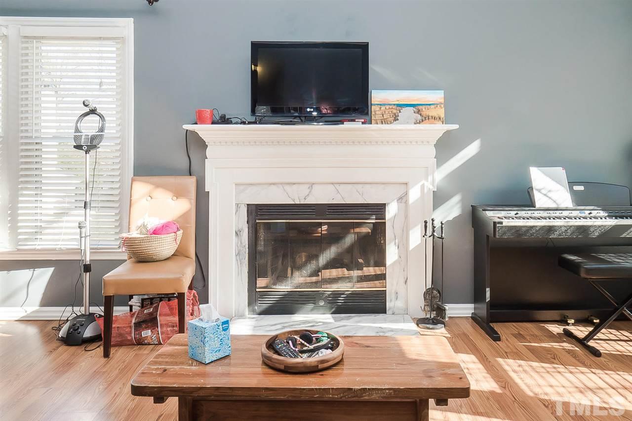 4125 Cobble Court Raleigh, NC 27616 - Photo 3 of 13 a living room with furniture and a fireplace
