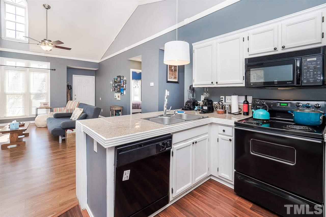 4125 Cobble Court Raleigh, NC 27616 - Photo 6 of 13 a kitchen with a sink stove and cabinets