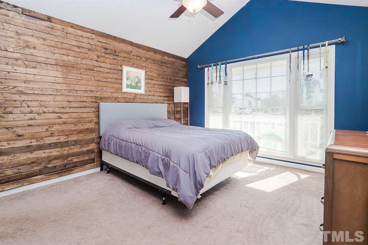 4125 Cobble Court Raleigh, NC 27616 - Photo 7 of 13 a bed sitting in a room next to a window