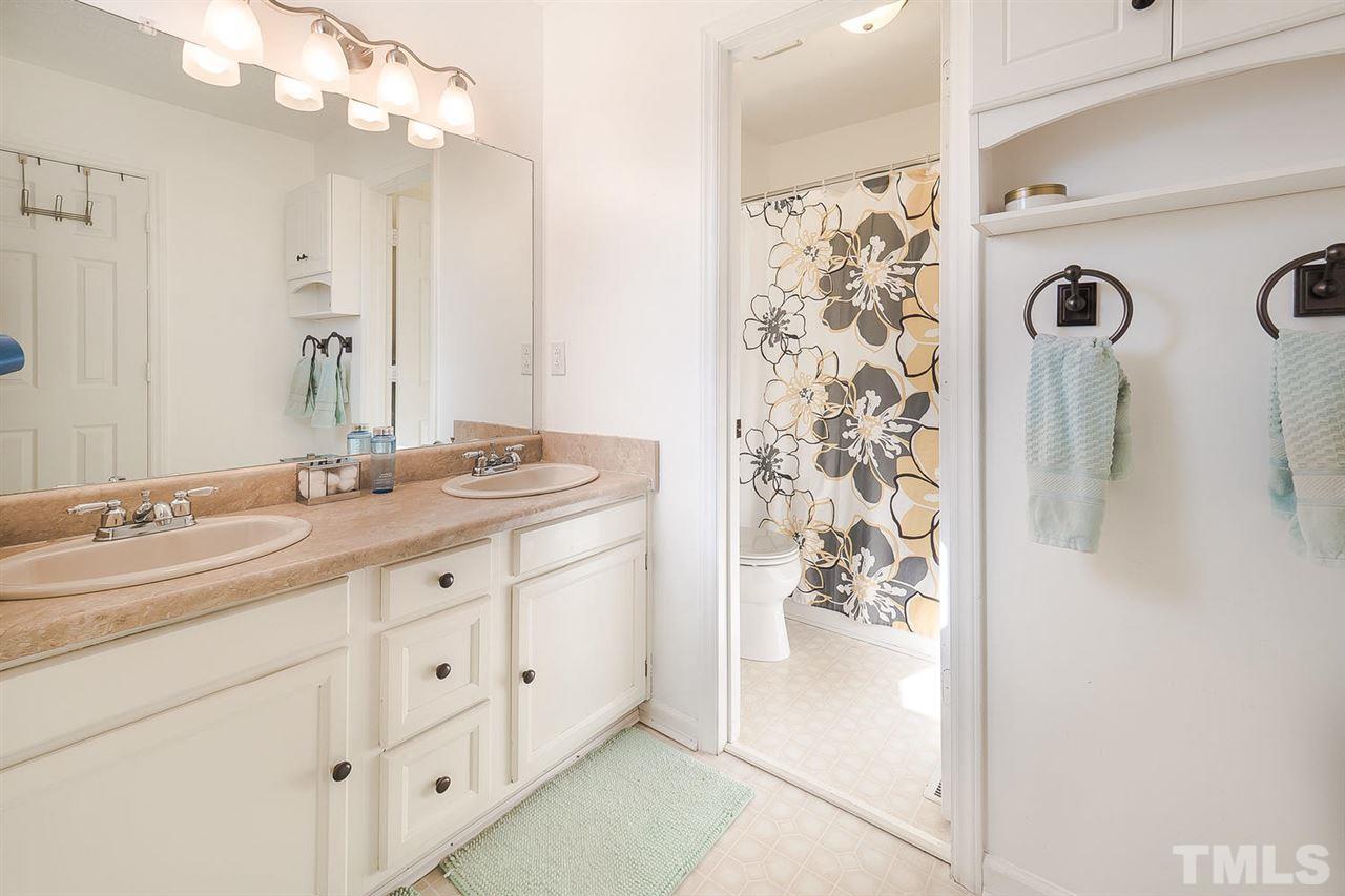 4125 Cobble Court Raleigh, NC 27616 - Photo 8 of 13 a bathroom with double sink and a mirror