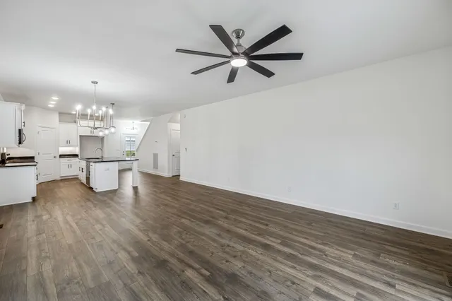 a living room with kitchen island furniture and a chandelier