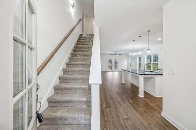 a view of entryway and hall with wooden floor