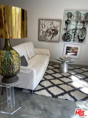a living room with furniture and floor to ceiling window
