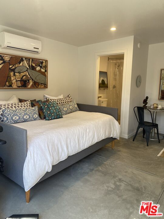 1053 South Alfred Street, Unit A Los Angeles, CA 90035 - Photo 3 of 11 a bedroom with a bed and wall painting