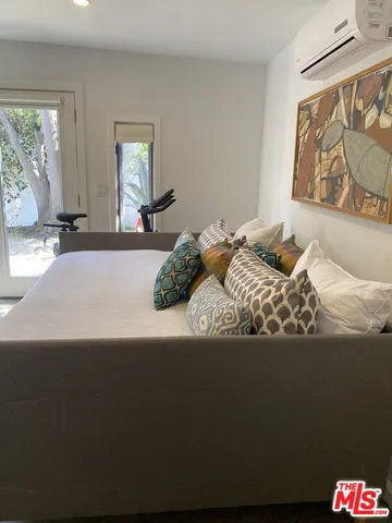 a bedroom with a bed and a large window