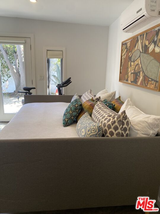 1053 South Alfred Street, Unit A Los Angeles, CA 90035 - Photo 5 of 11 a bedroom with a bed and a large window