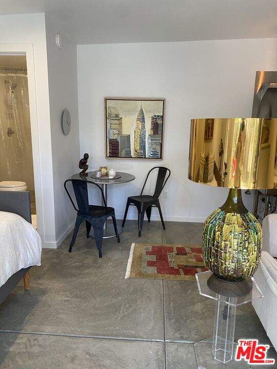 1053 South Alfred Street, Unit A Los Angeles, CA 90035 - Photo 6 of 11 a living room with furniture and a potted plant