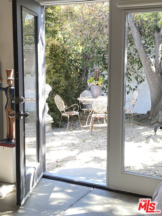 1053 South Alfred Street, Unit A Los Angeles, CA 90035 - Photo 10 of 11 a view of a porch with furniture and front door
