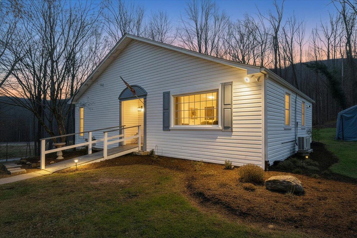 a backyard of a house with table and chairs