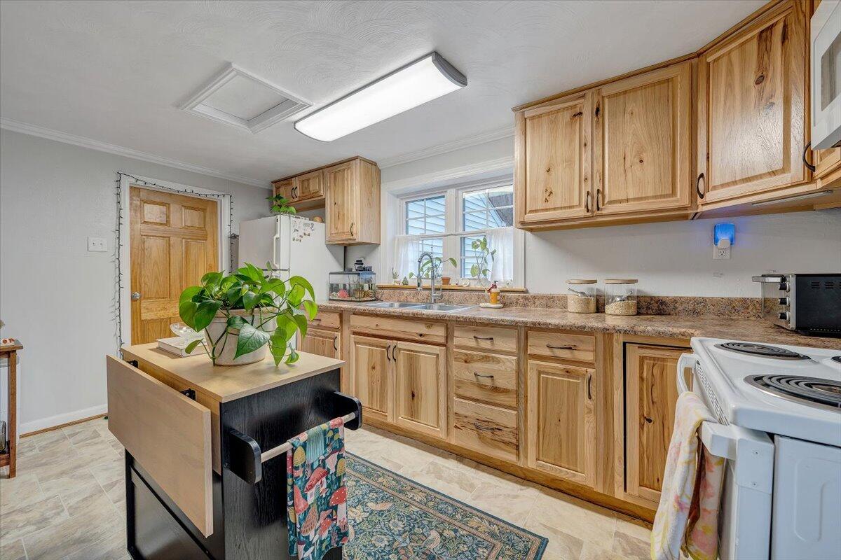 7346 Old Mill Road Roanoke, VA 24018 - Photo 13 of 48 a kitchen with stainless steel appliances granite countertop a stove a sink dishwasher and cabinets with wooden floor