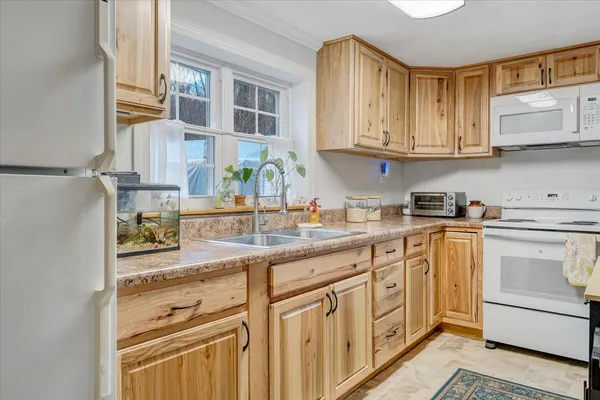 a kitchen with stainless steel appliances granite countertop a sink and cabinets