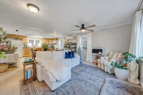 a living room with furniture and kitchen view
