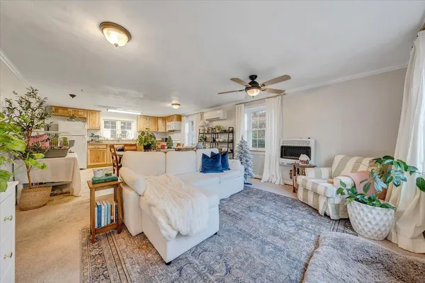 a living room with furniture and a chandelier