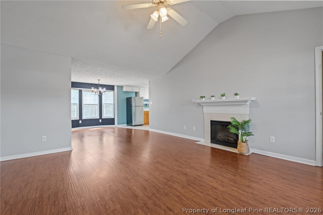 115 Shelby Street Spring Lake, NC 28390 - Photo 7 of 40 an empty room with wooden floor fireplace and windows