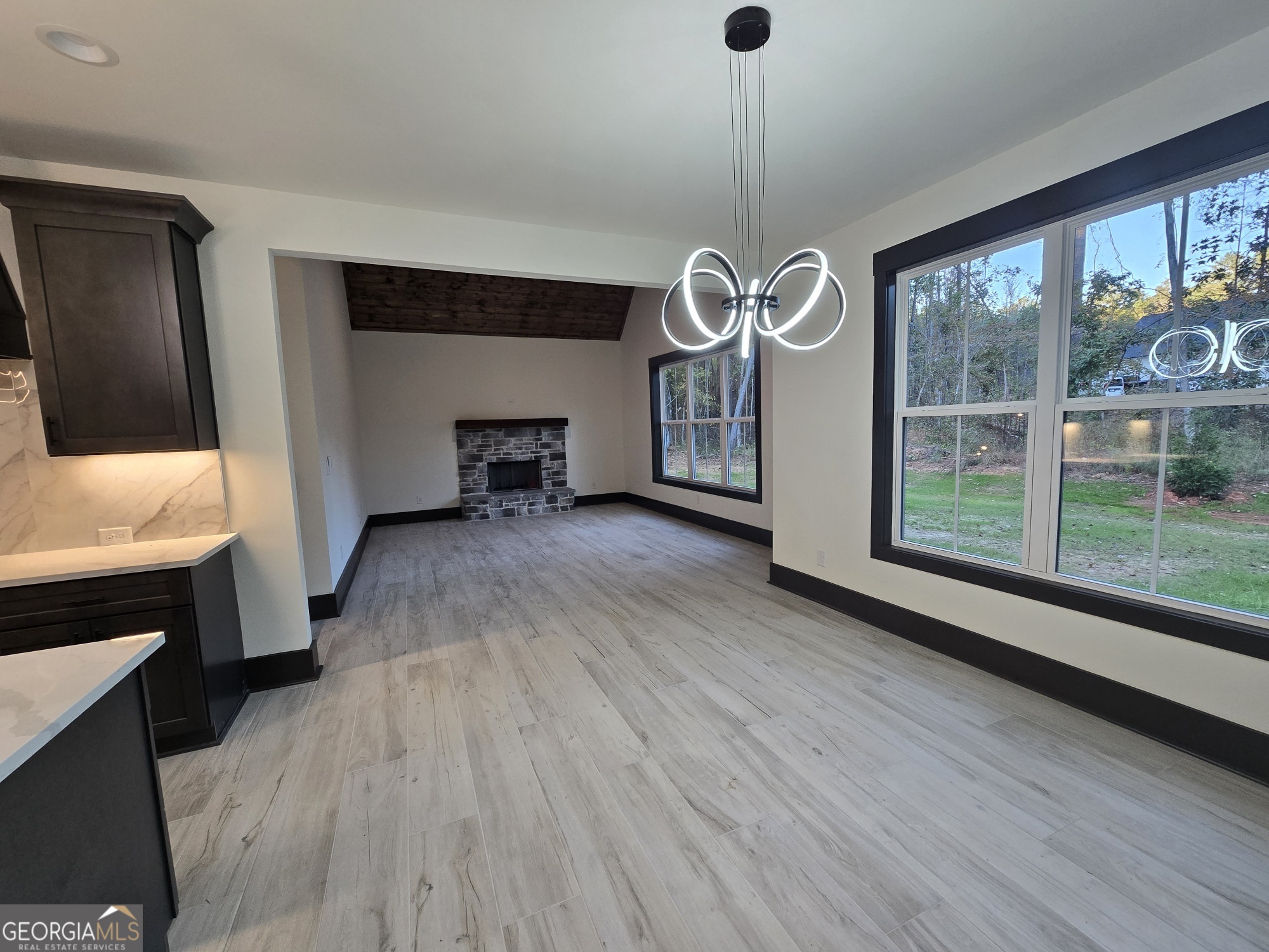 2043 Fischer Road Sharpsburg, GA 30277 - Photo 15 of 51 a view of an empty room with wooden floor and a window