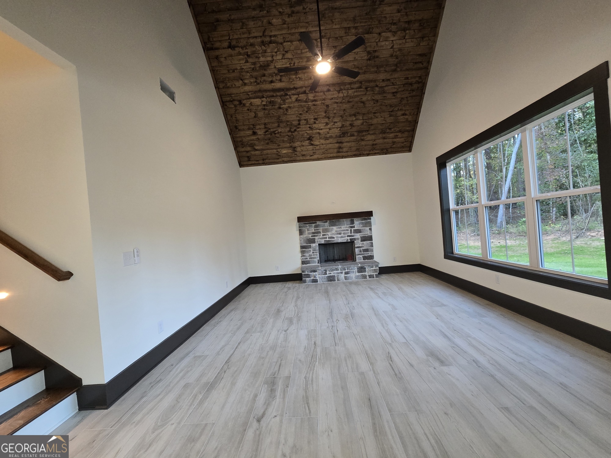 2043 Fischer Road Sharpsburg, GA 30277 - Photo 20 of 51 a view of empty room with wooden floor and fireplace