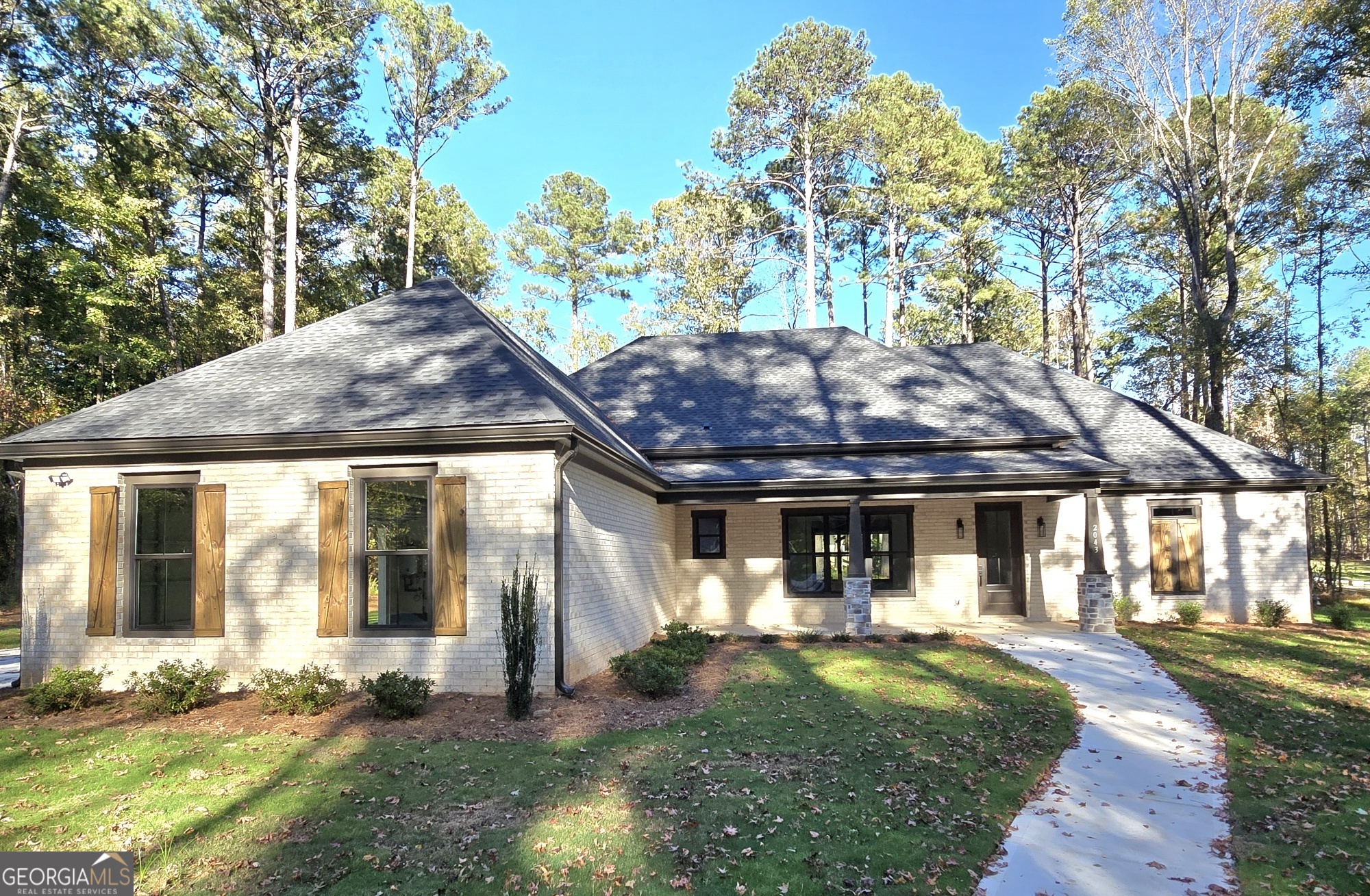 2043 Fischer Road Sharpsburg, GA 30277 - Photo 2 of 51 a front view of a house with garden