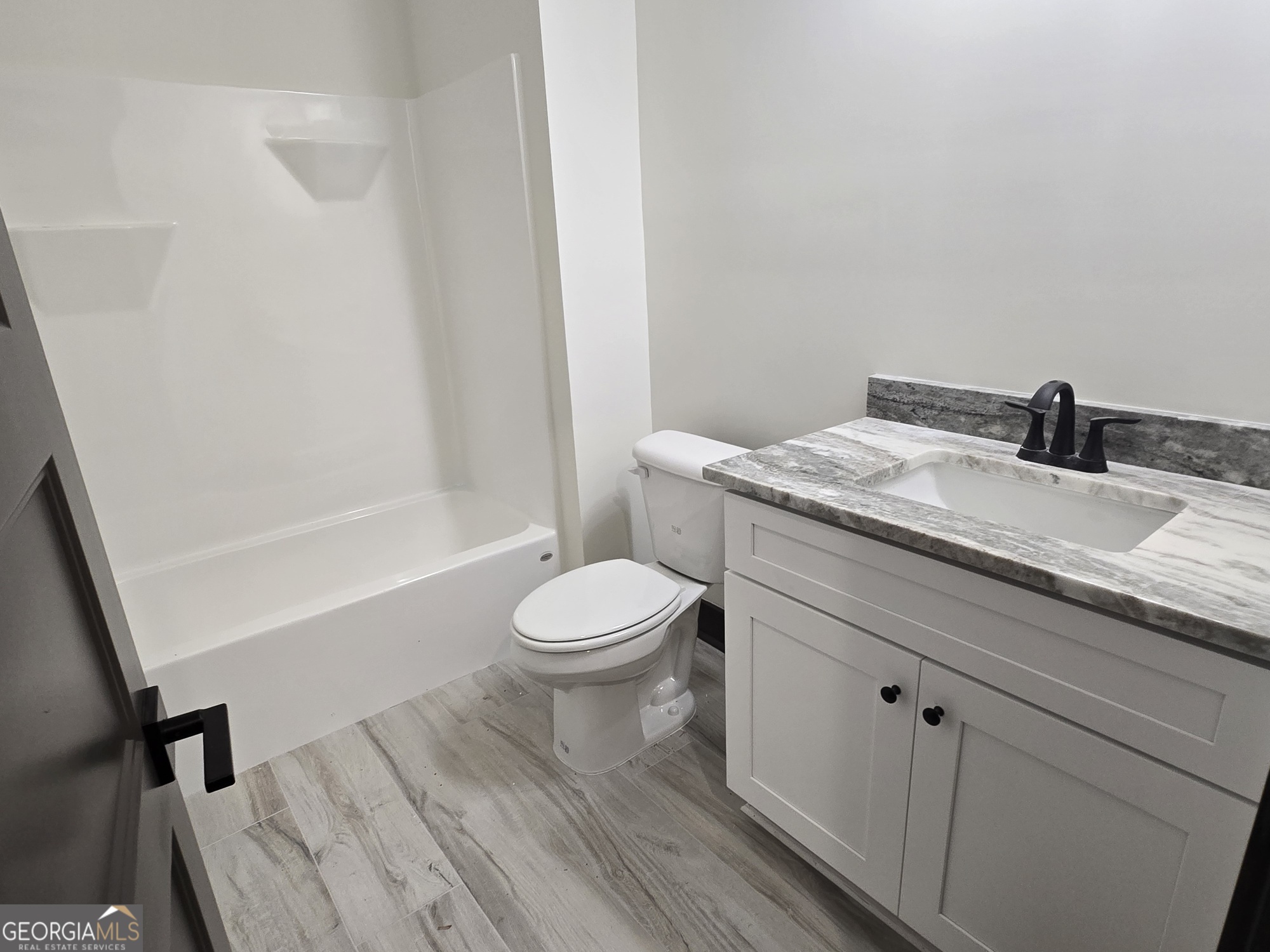 2043 Fischer Road Sharpsburg, GA 30277 - Photo 45 of 51 a bathroom with a granite countertop sink toilet and shower