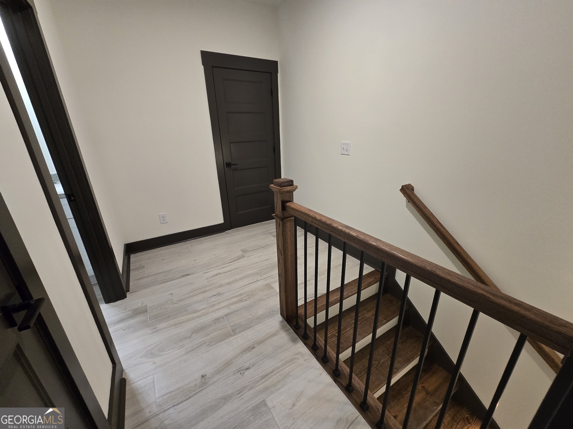 2043 Fischer Road Sharpsburg, GA 30277 - Photo 47 of 51 a view of a hallway with wooden floor and stairs