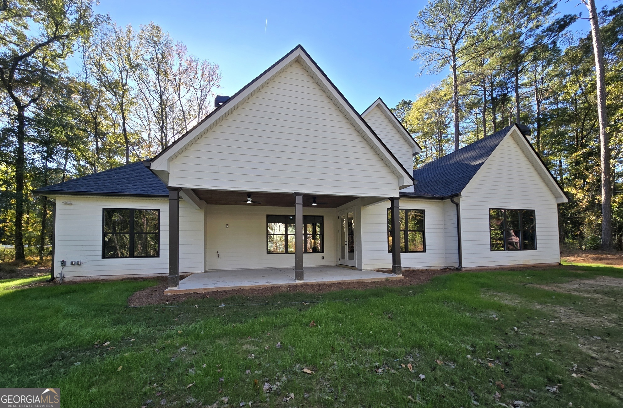 2043 Fischer Road Sharpsburg, GA 30277 - Photo 49 of 51 a front view of a house with a yard and trees