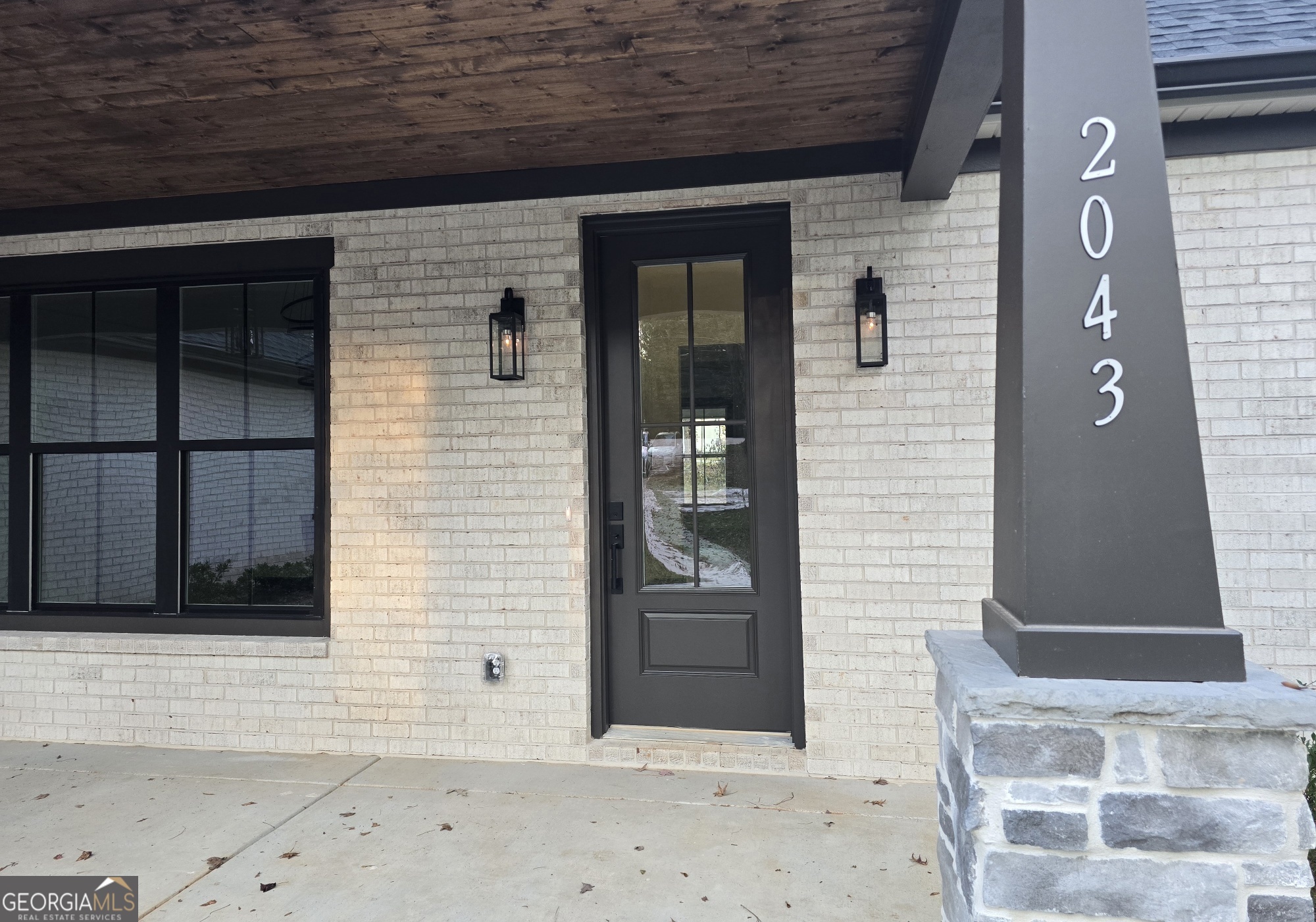 2043 Fischer Road Sharpsburg, GA 30277 - Photo 5 of 51 a front view of a house with a glass door